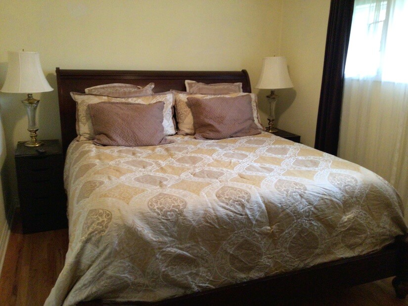 King size comfy bed with two nightstands and lamps.