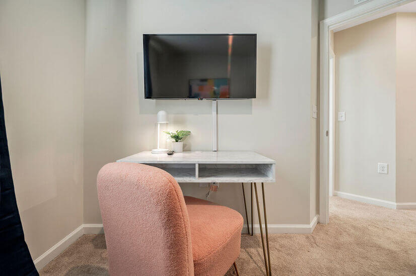Smart TV, designated desk and pink chair