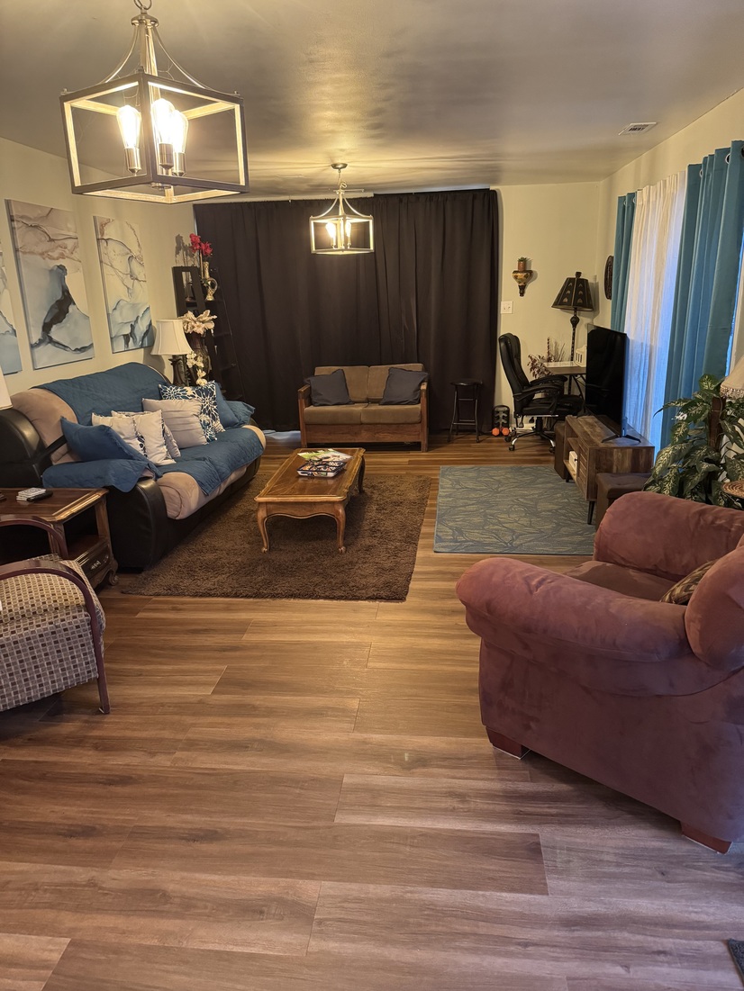 Living room  and den divided by curtains