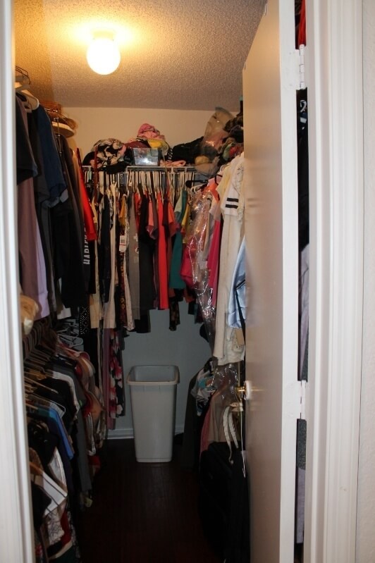 Large walk in closet with two-tier shelving