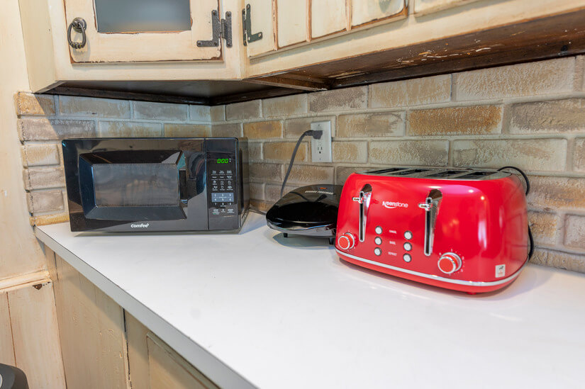 Small appliances include microwave, panini press, + toaster.