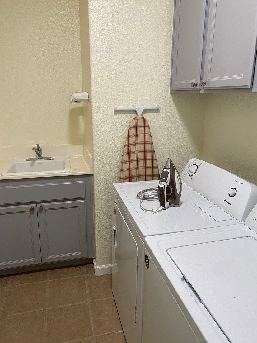 laundry room with iron and ironing board