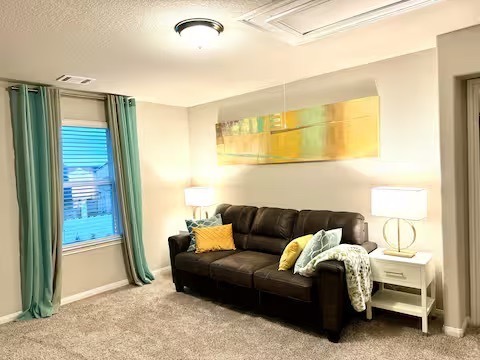 Spacious game room with couch and TV.