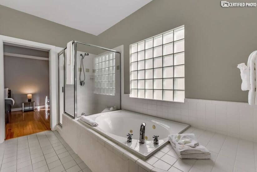 Bathroom downstairs with shower stand and bath tub