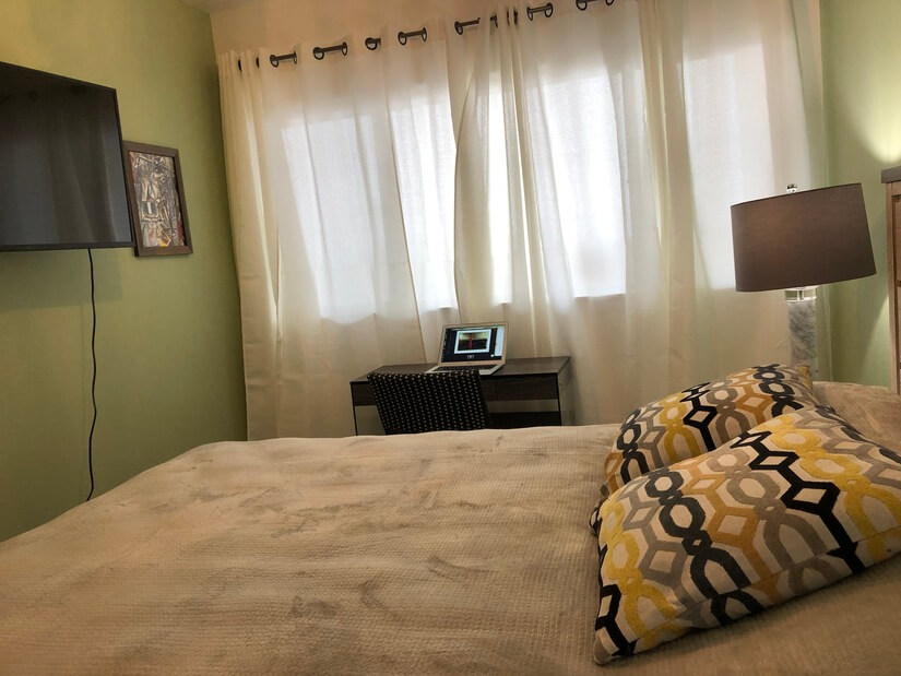 Green Bedroom with a desk and street view