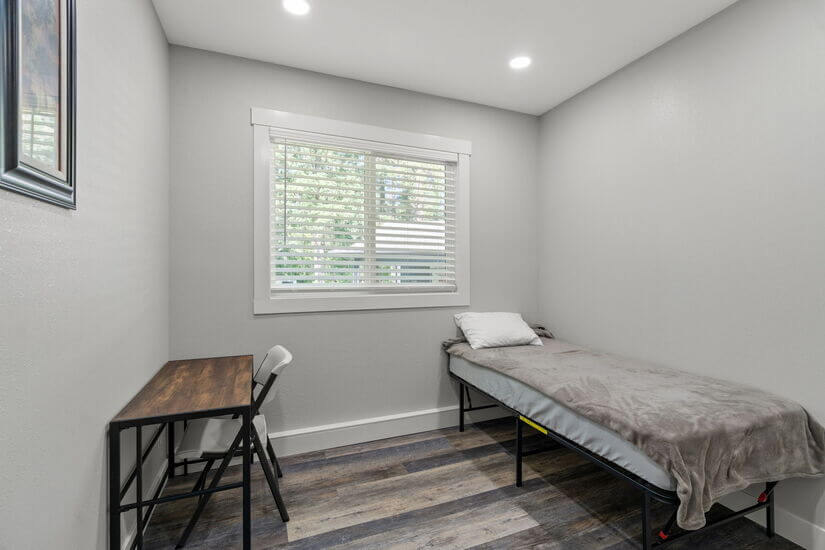 Bedroom with twin bed and desk