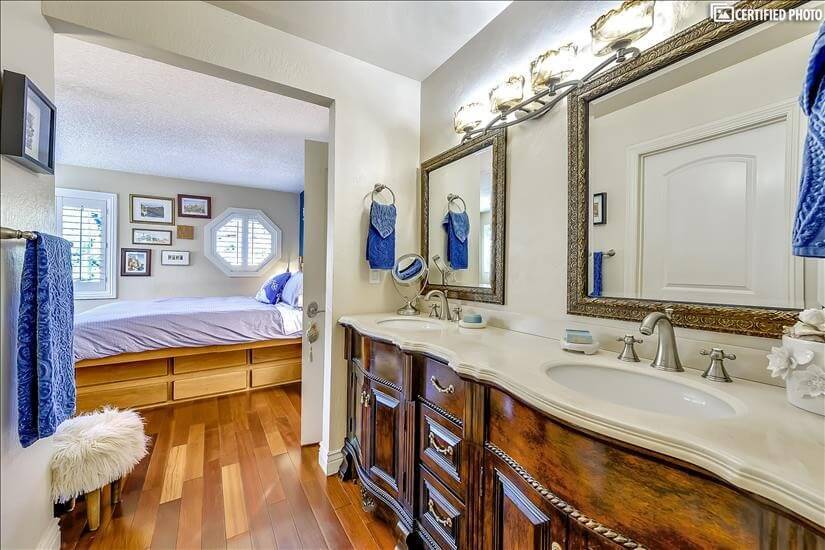 Double vanity connects to master bedroom.