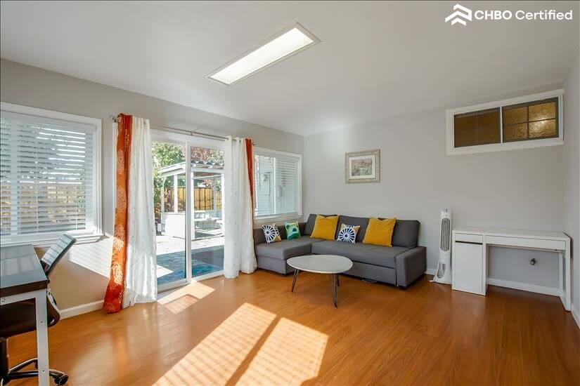 Well-lit sunroom with access to backyard