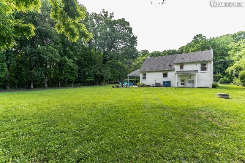 Large fenced in 1 acre lot surrounded by trees in the back.