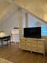 primary bedroom with a 55-inch Smart TV