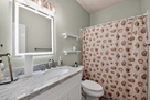 2nd bath with updated vanity, mirror, and sho
