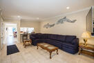 Living space with huge couch and 55" flat scr
