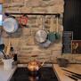 Stove with rustic  stone backsplash.