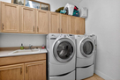Laundry room between guest powder room and ga