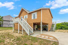 Carport with steps to front door and deck