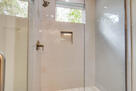 Modern walk-in shower with glass doors and br