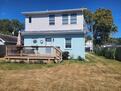 back of house with privacy fence & gas grill