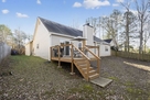 Fenced in backyard with deck.