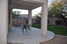Large covered patio with turf fenced backyard