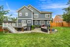 Large backyard with flagstone patio and deck