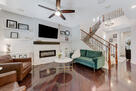 living area, stone fireplace, wood flooring