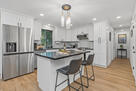 Open layout, island seating, and deck access.