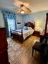 Soothing blue bedroom with Queen bed.