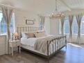 A light-filled bedroom with a comfortable bed