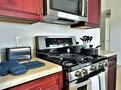 Fully stocked kitchen with pans and dishes