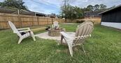 Large private fenced backyard with firepit