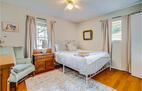 Queen bedroom with seating and dresser