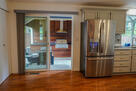 Sliding doors open to outdoor grill area