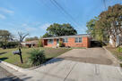 Street view of property with driveway parking