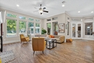 Sunlit living room with backyard views
