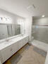 double vanity, glass shower with bench