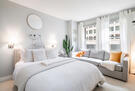 Cozy bedroom with comfy mattress and a couch