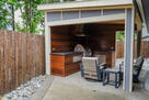 Custom wood-paneled outdoor kitchen w seating