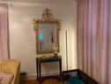 Grand mirror over marble table greets you.