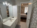 Spacious well lit Bathroom with ceramic tiles