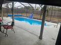 Lanai with inground pool and attached pool li
