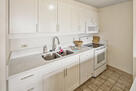 sink view with stove and microwave