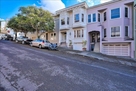 View of property (White home, top floor unit)