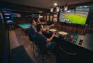 Large screen TV and bar seating.