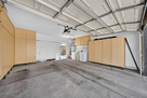 2 car garage with built in cabinets and washe