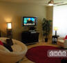Natural hardwood floors in the main area are