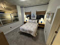 Brightly lit bedroom with 43 inch TV