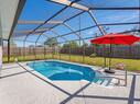 Sunny Pool Area with Outdoor Seating