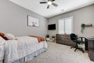 primary downstairs bedroom, desk, ceiling fan