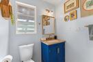 Full bathroom with blue/gold vibes