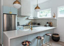 Modern kitchen with pendant lights & bar top